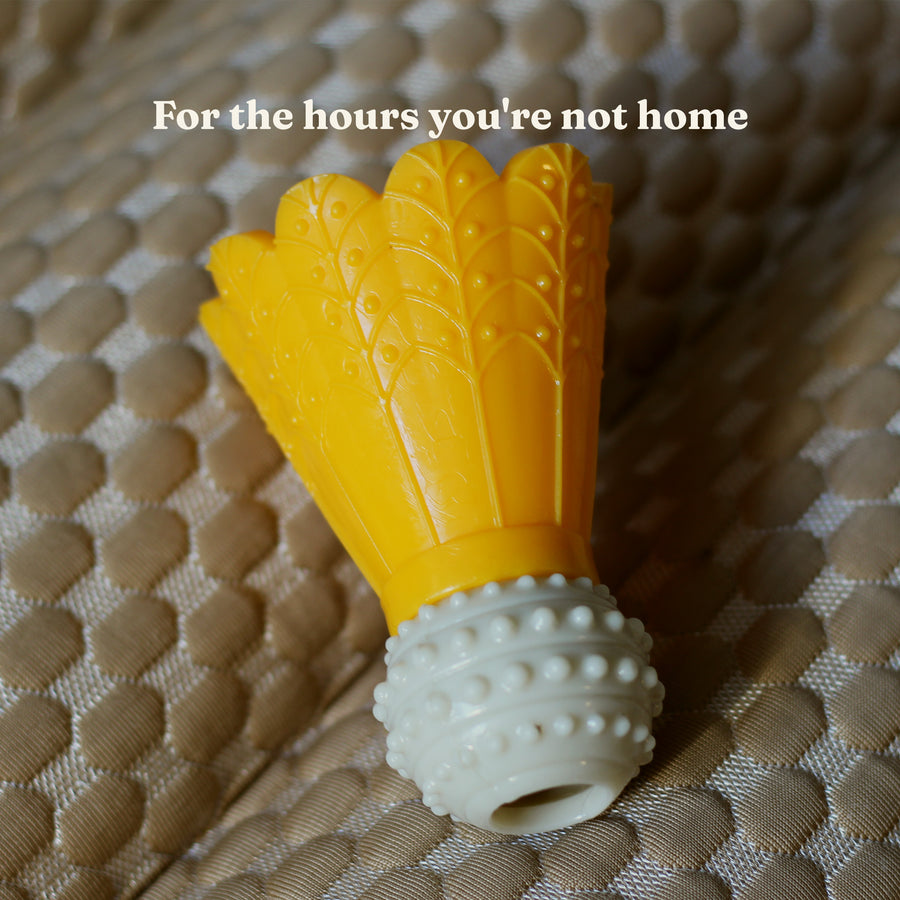 Yellow Busy Chew fillable dog toy, shuttlecock shaped with a knobbly textured base