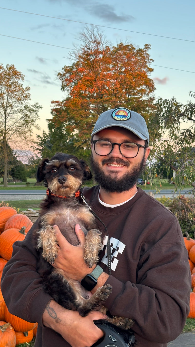 Eduardo Schlichting, founder of Toque & Pooch, holding his rescue dog Zeus